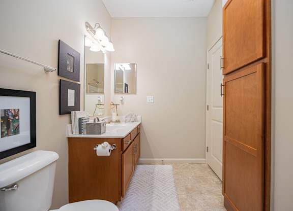 A bathroom with a white tub, sink, and toilet.