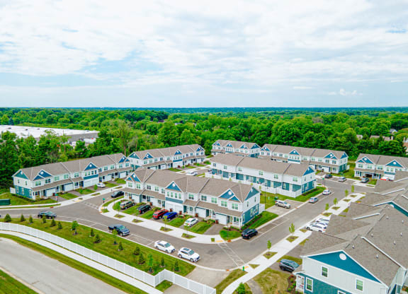 an aerial view of a group of houses in a parking lot