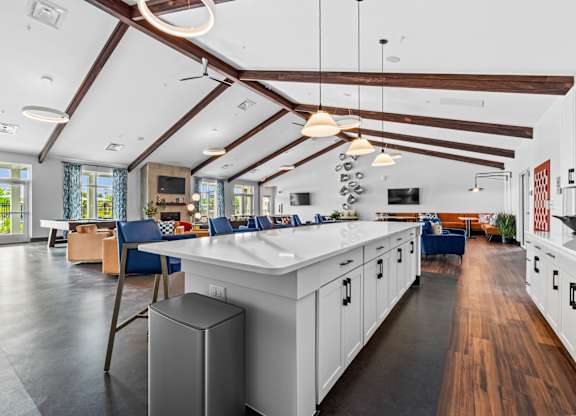 A modern kitchen with white cabinets and a large island.