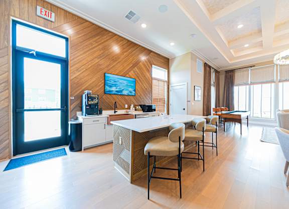 A modern kitchen with a bar area and a dining table.