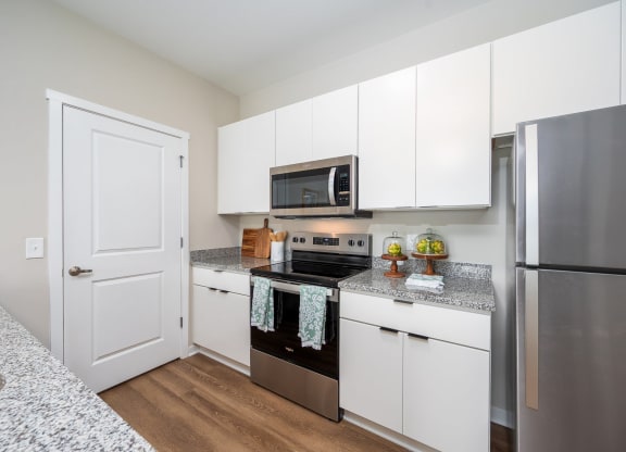 a kitchen with stainless steel appliances and granite counter tops