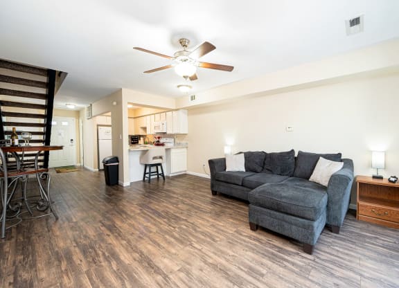 a living room with a couch and a ceiling fan