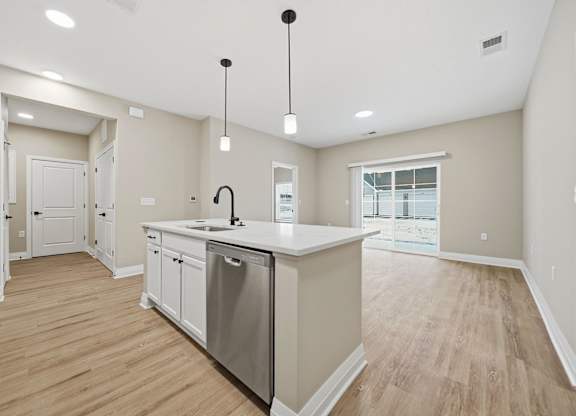 A kitchen with a large island and stainless steel appliances.