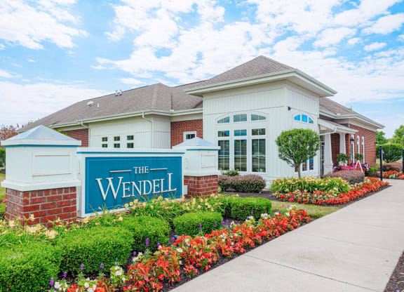 the residences at the wendel building entrance with flowers and plants