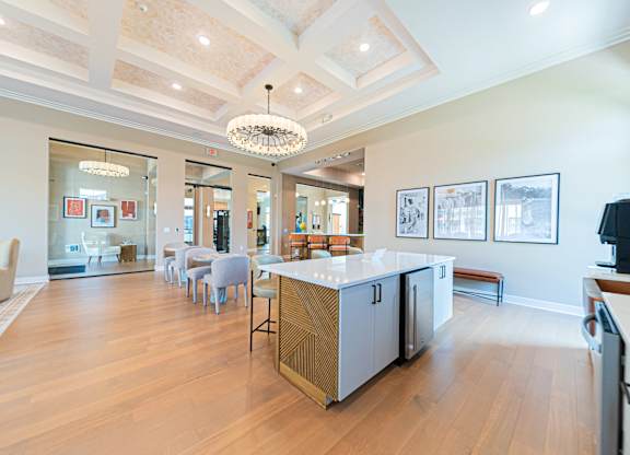 A kitchen with a wooden floor and a white ceiling.