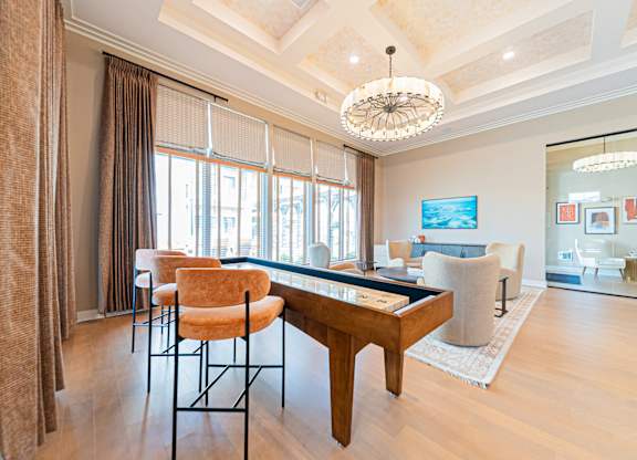 A living room with a brown chair and a wooden table.