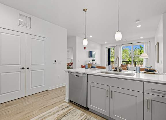 A modern kitchen with white cabinets and a large island.