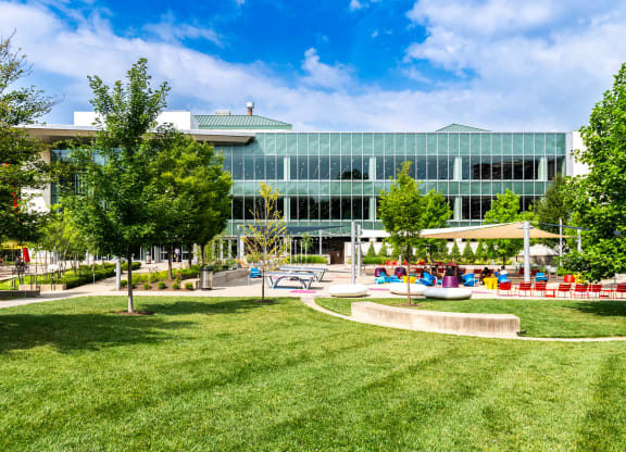 a large building with a park in front of it