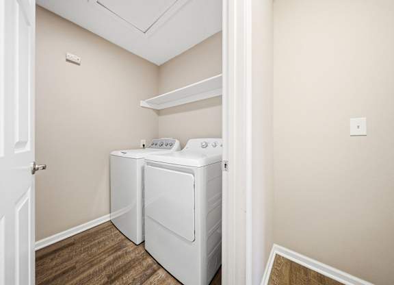 A small laundry room with a washer and dryer.