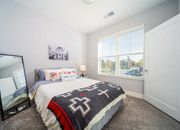a bedroom with a bed and a window