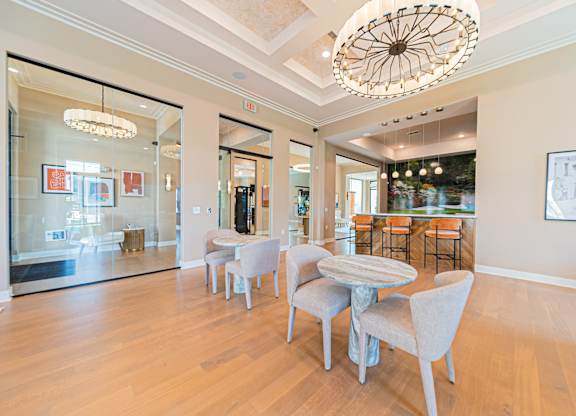 A dining room with a table and chairs.