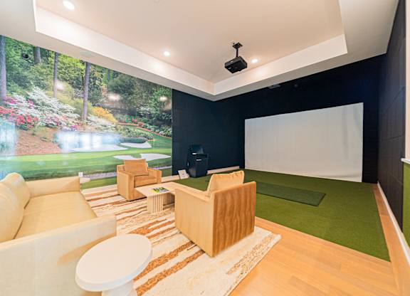 A living room with a large picture of a garden on the wall.