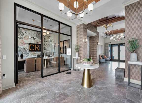 A modern interior with a glass door entrance and a round table in the center.