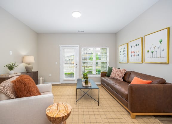 a living room with a leather couch and a coffee table
