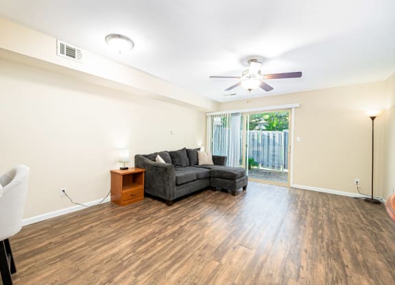 a living room with a couch and a ceiling fan