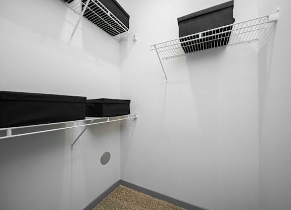 A storage room with two shelves and a ventilation system.