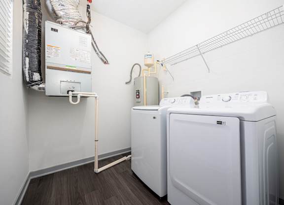 A small laundry room with a washer and dryer.