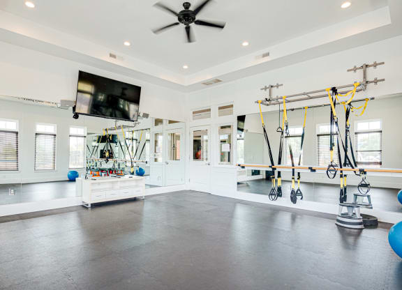 a home gym with weights and a tv on the wall