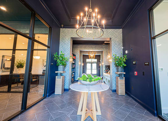 a lobby with a table with a bowl of fruit on it