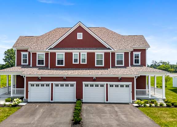 A red house with a white garage door.