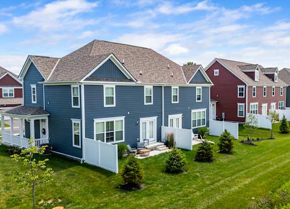 A row of houses with a blue house in the front.