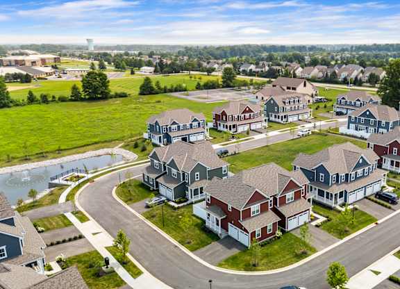 A suburban neighborhood with houses and a pond.
