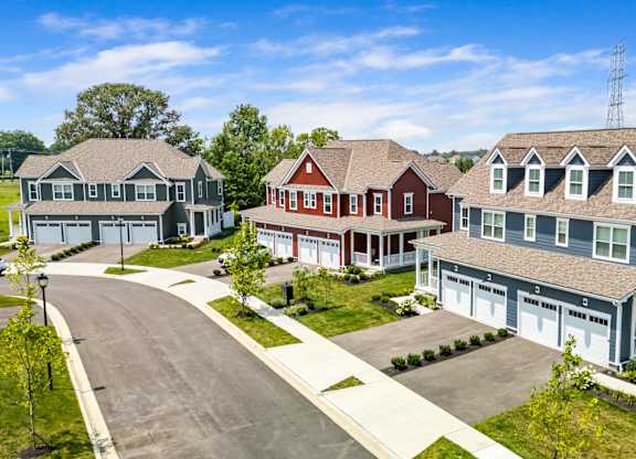 A row of houses with a cell tower in the background.