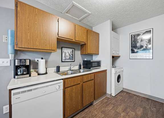 A kitchen with wooden cabinets and white appliances.