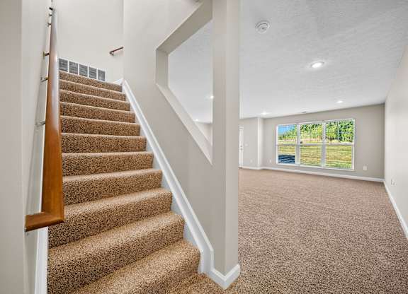 A room with a staircase leading to the upper floor.