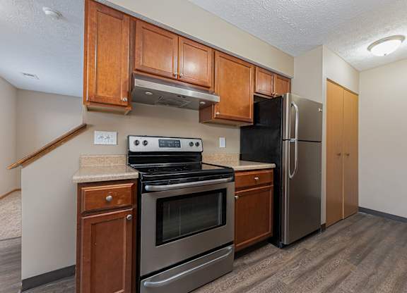 A kitchen with a stove, oven, and refrigerator.