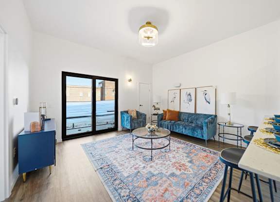 A living room with a blue couch and a coffee table.