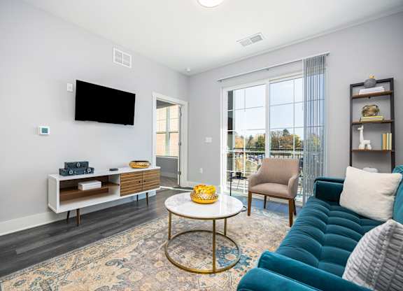 a living room with a blue couch and a table