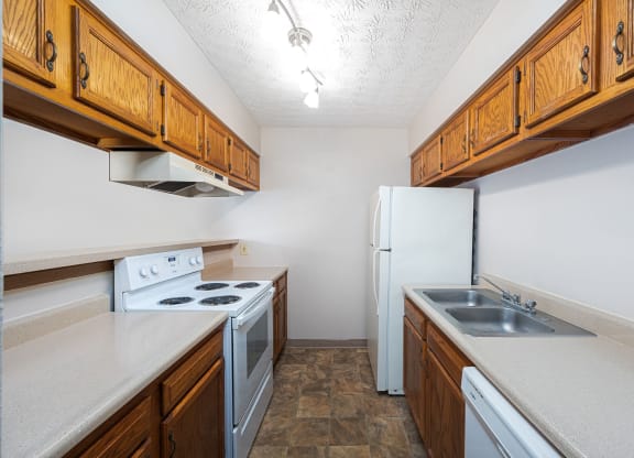 a kitchen with white appliances and wooden cabinets