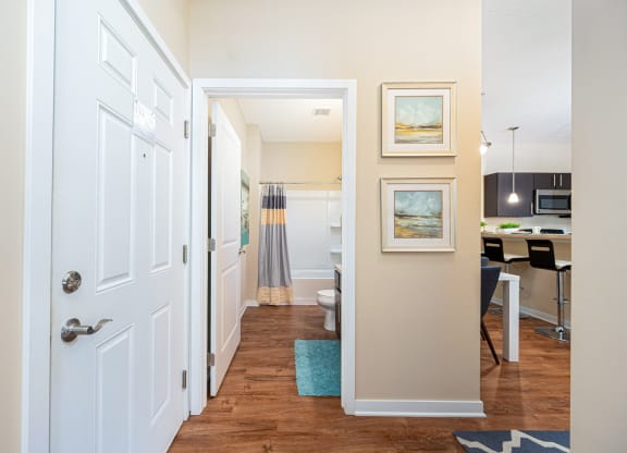 a hallway with a door to a kitchen and a living room