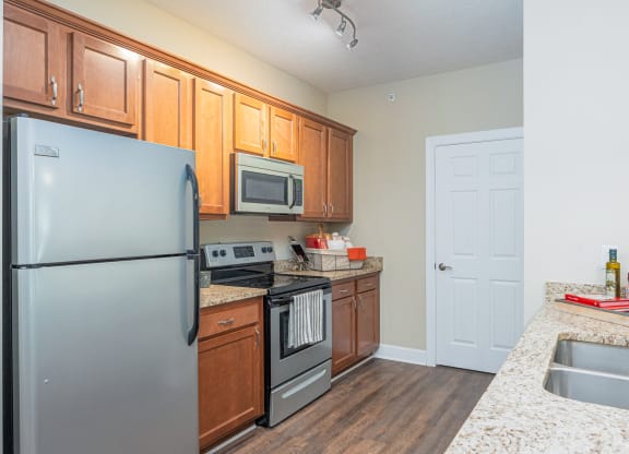 a kitchen with stainless steel appliances and granite counter tops