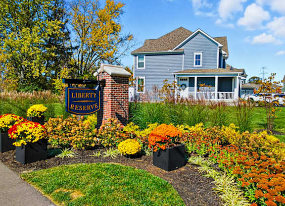 A sign that says "Liberty Reserve" in front of a house.