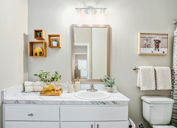 a white bathroom with a sink and a mirror