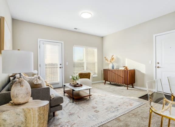 a living room with a couch and chairs and a table