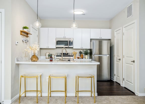 a kitchen with white cabinets and a white counter top