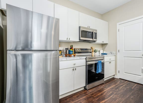 a kitchen with pink and white walls and a stove