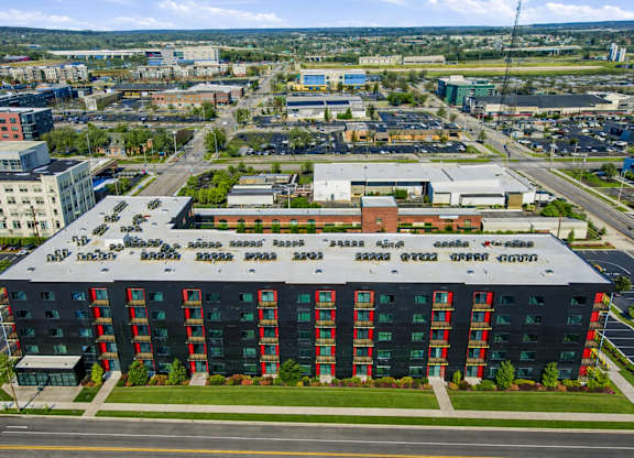 A large building with a red and green facade is the main focus of the image.