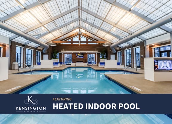a heated indoor pool with a glass ceiling