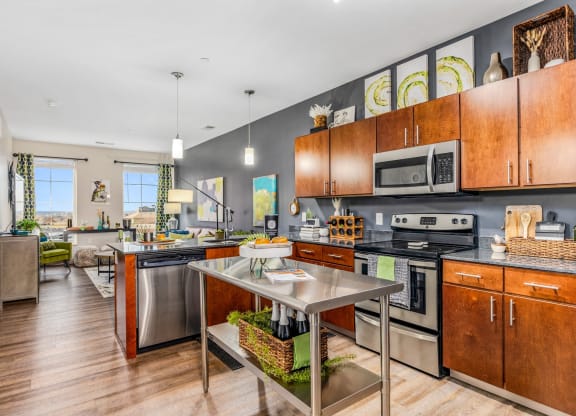 a large kitchen with stainless steel appliances and wooden cabinets