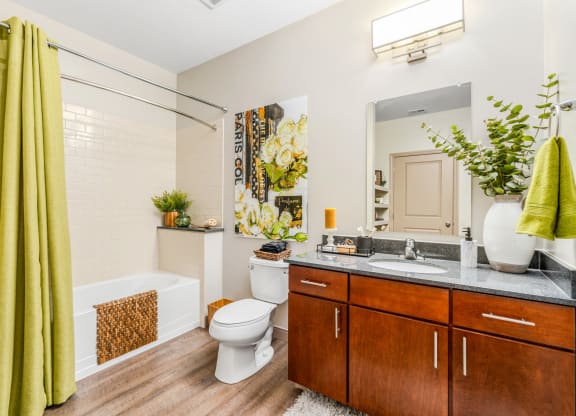 a bathroom with a toilet and a sink and a tub