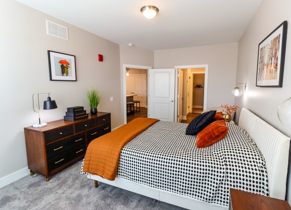 a bedroom with a bed and dresser