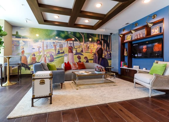 a living room with a large mural on the wall
