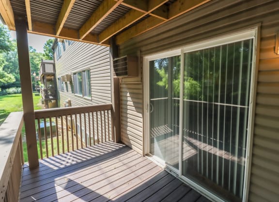 a covered porch with glass doors on a house