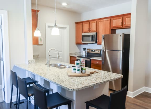 a kitchen with a granite counter top and stainless steel appliances