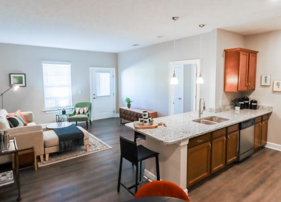 a living room and kitchen with a couch and a table