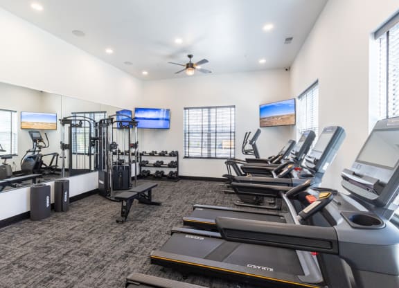 the gym with treadmills and cardio equipment at the belgard apartments